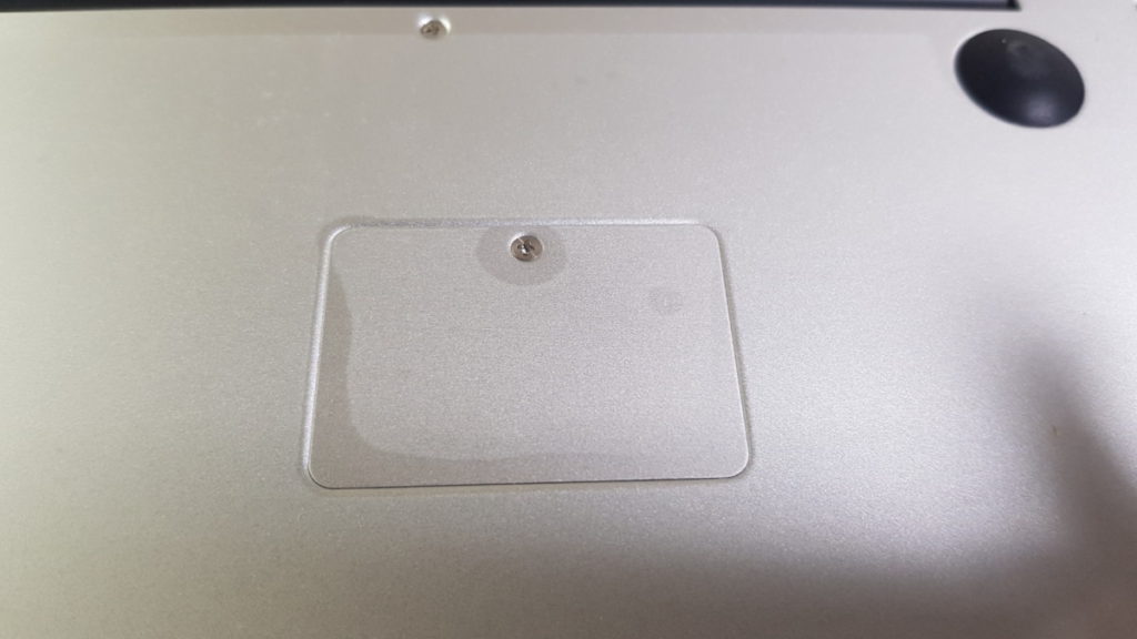 The M.2 SSD slot access port prior to the removal of the protective plastic sheeting.