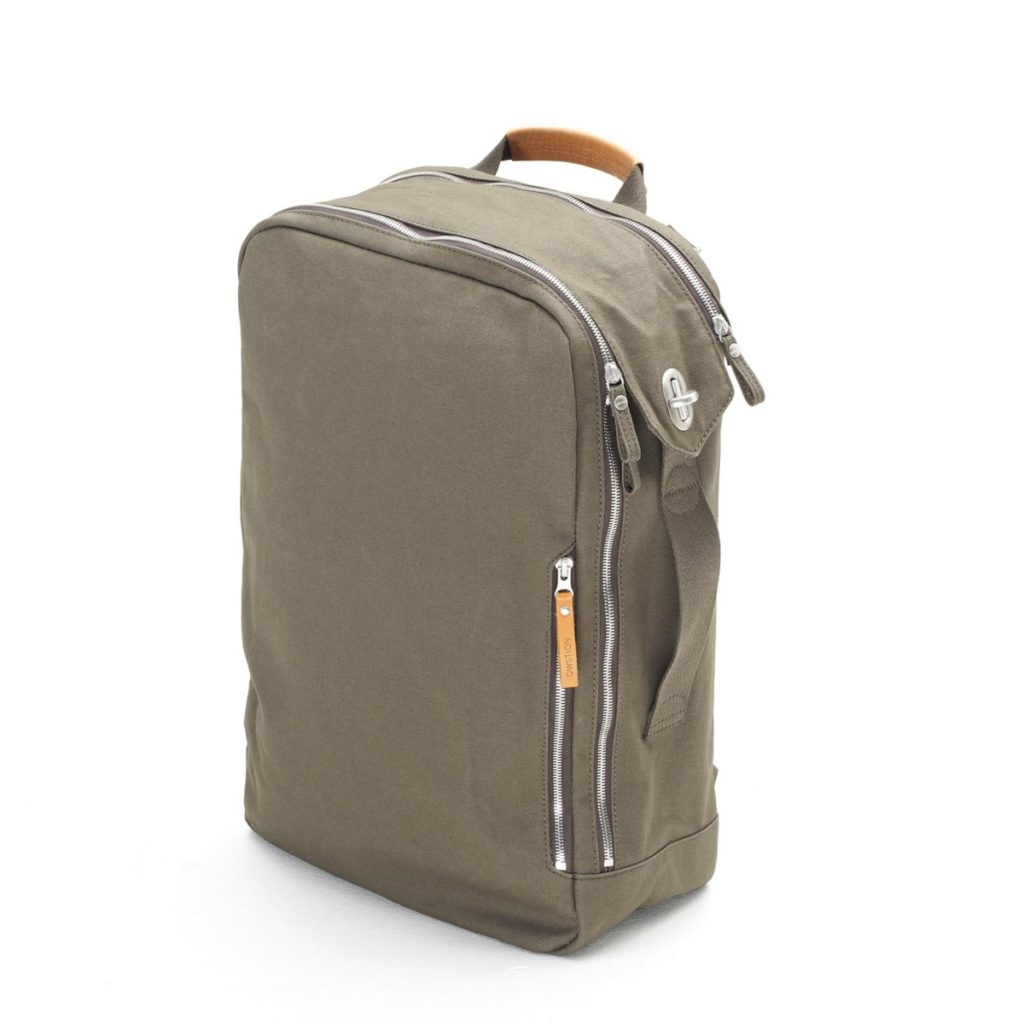The QWSTION backpack in forest green can be used backpack-style or like a briefcase via the side-mounted carrying handles