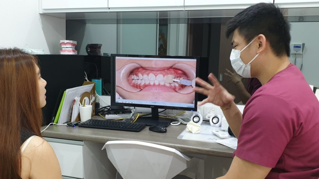 Dr. Chong briefs a patient on what to expect during the Zoom Teeth Whitening procedure.